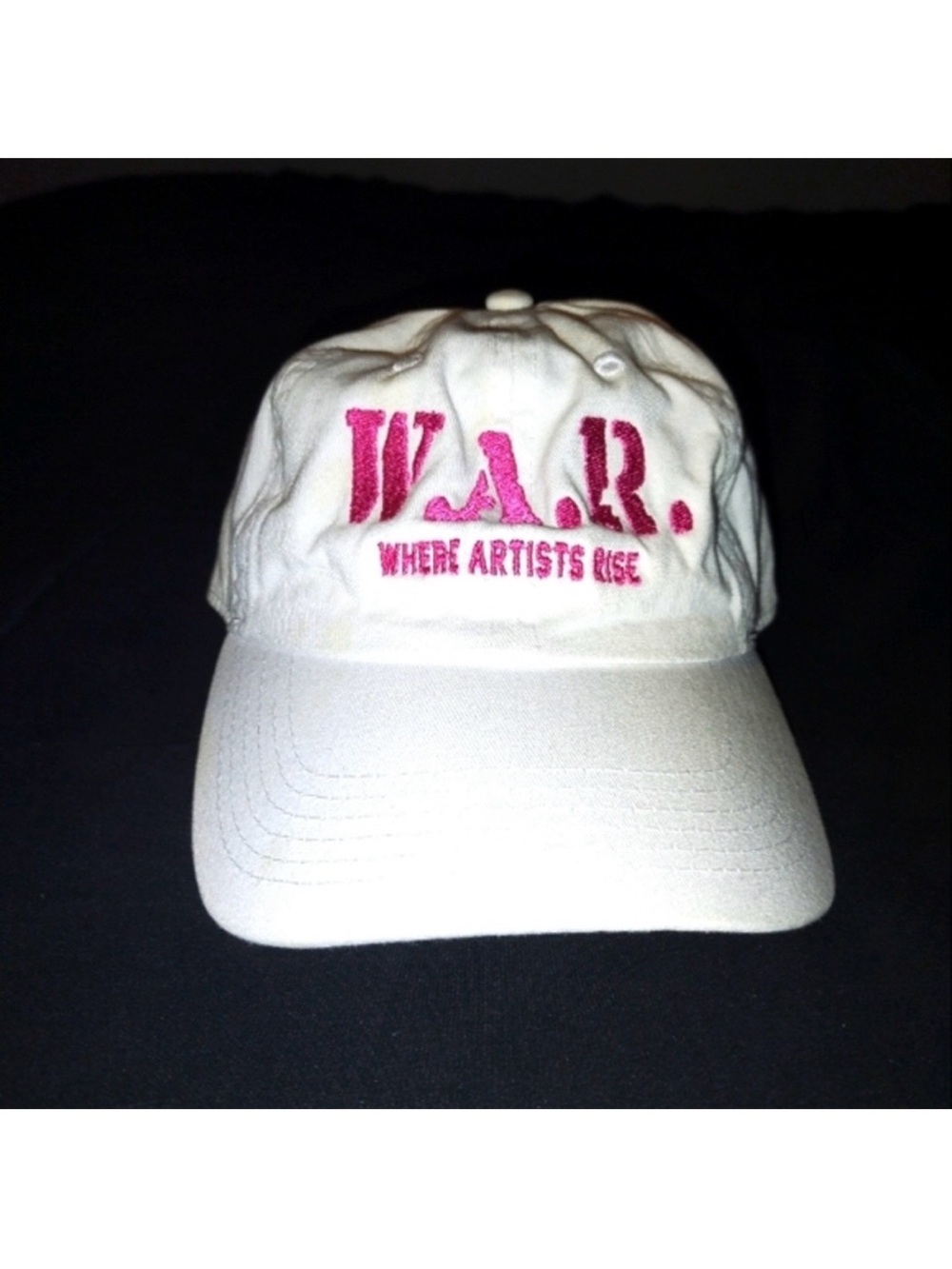 Adjustable White Hat Cap With Pink W.A.R. Letters And Where Artists Rise Written